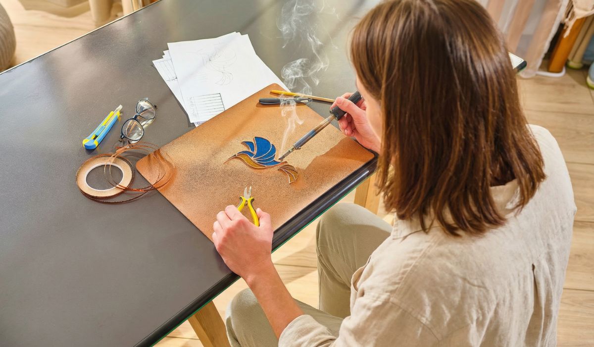 Making stained glass — soldering the hummingbird piece